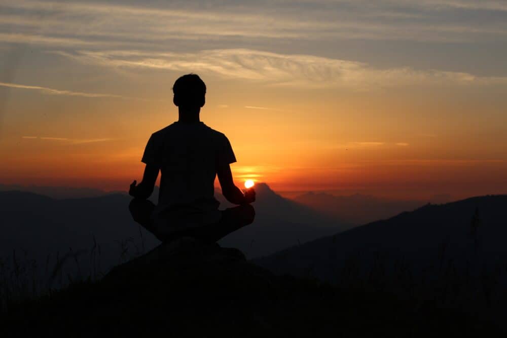 guy meditating on mountain