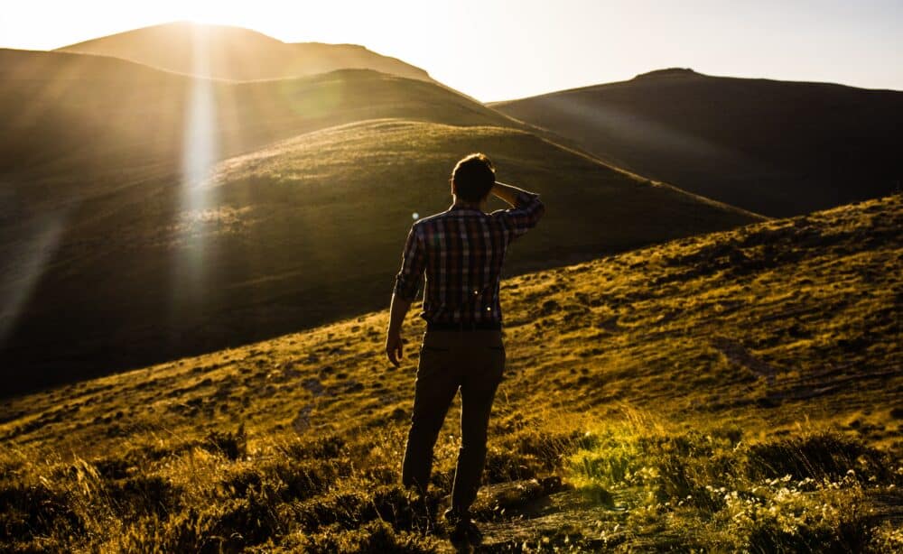 man walking on hills