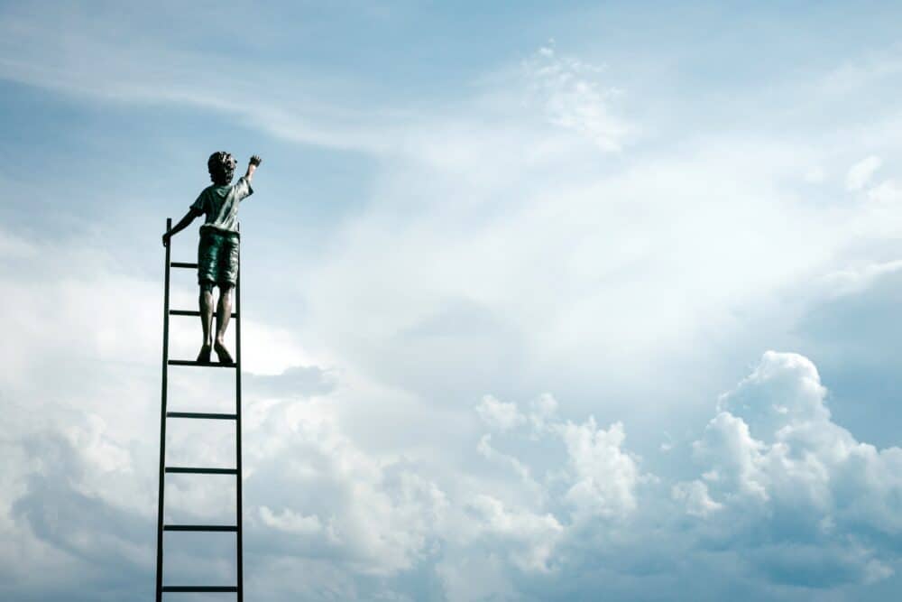 boy reaching for the clouds