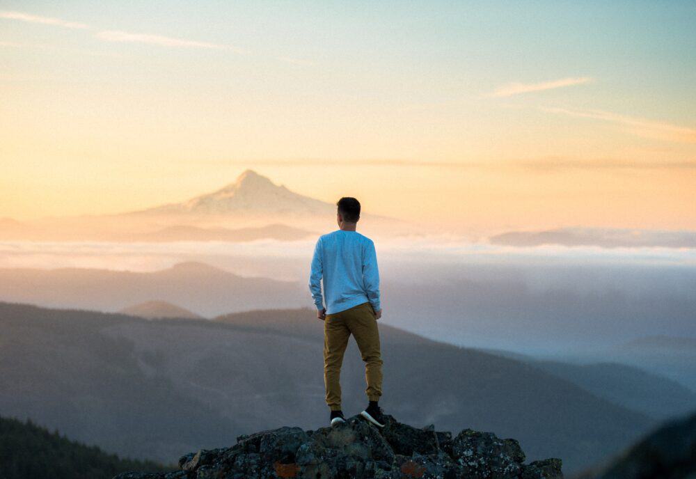 man on top of mountain